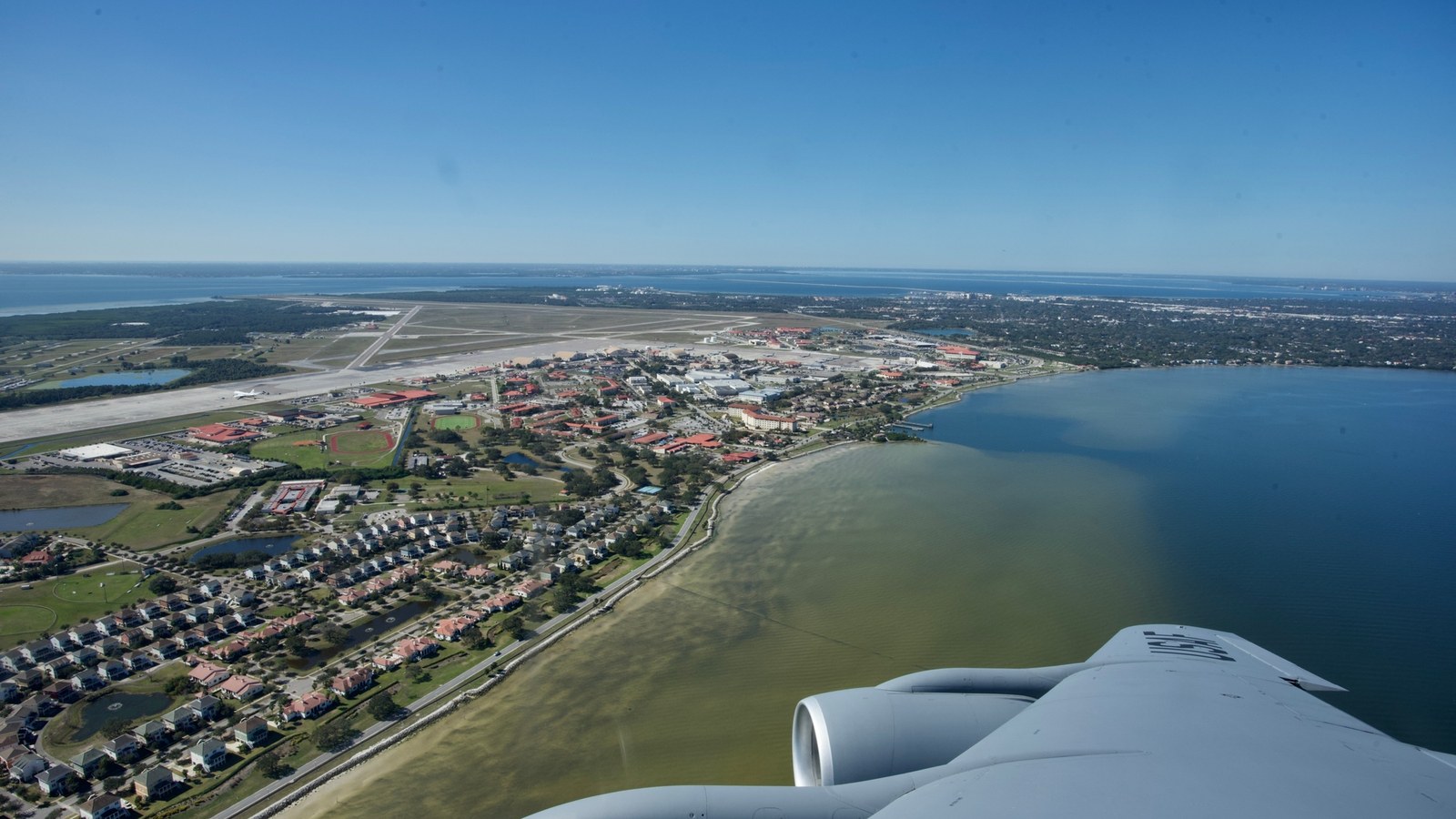 Aerial view of MacDill Air Force Base along Tampa Bay from an aircraft wing